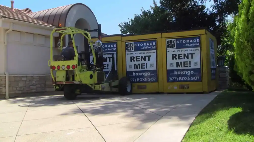 Forklift delivering Box-n-Go portable storage units to a residential driveway in Montrose, showcasing convenient portable storage Montrose solutions for moving and on-site storage needs.