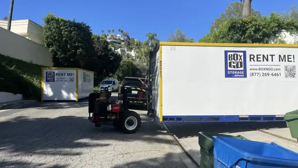 Storage 91020 Portable storage Montrose units being delivered on a residential hillside street, with a forklift positioning a large Box-n-Go mobile storage container near homes.