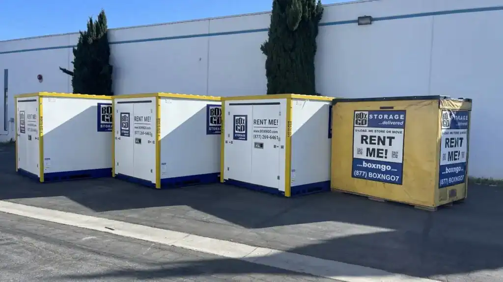 Portable storage Montrose units lined up outdoors, featuring Box-n-Go portable storage containers available for rent, showing durable mobile storage solutions in a commercial facility.