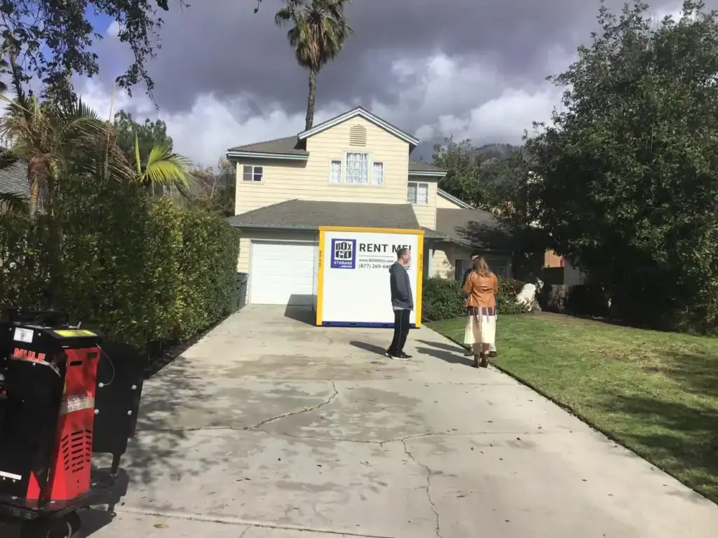 Portable storage Reseda unit delivered to a residential driveway, with a Box-n-Go portable storage container being set up in front of a home for convenient loading and local storage needs in Reseda.