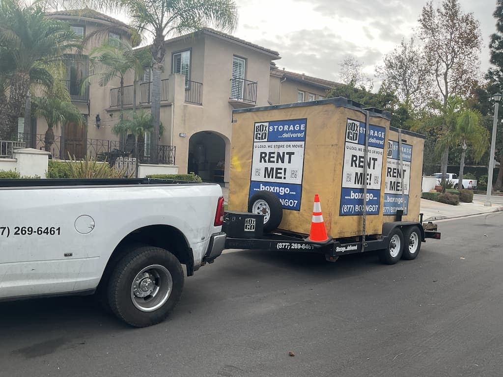 west la mini storage container positioned on a driveway near homes or apartments