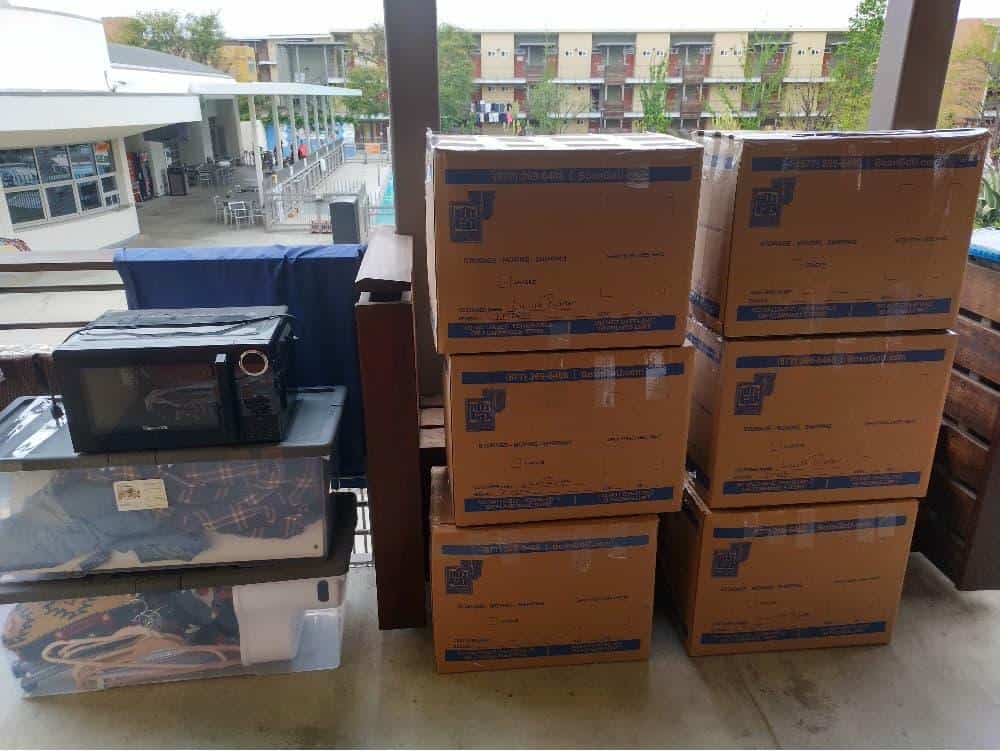 Student items including boxes and a microwave packed and labeled for Affordable storage units for Harvey Mudd students.