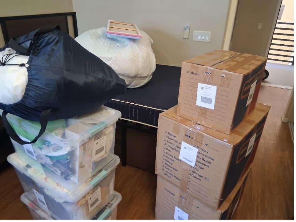 Student items including boxes and clear bins packed and labeled for self storage student discount.