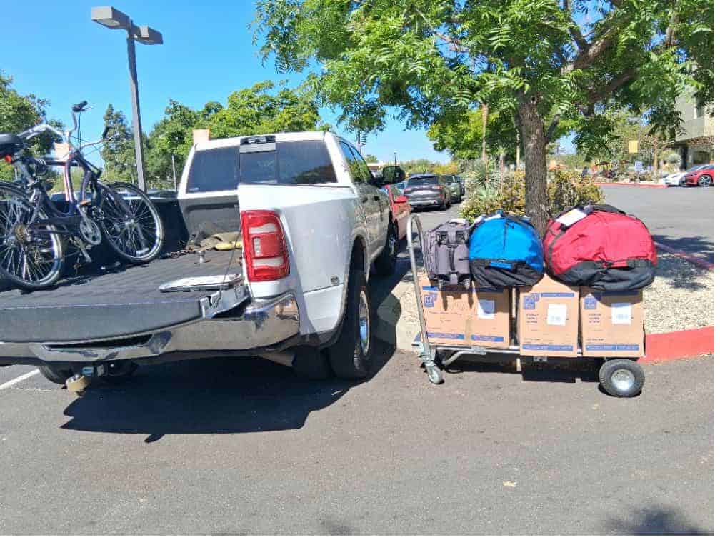 Student items including clear bins with clothes packed and labeled for storage 90045.
