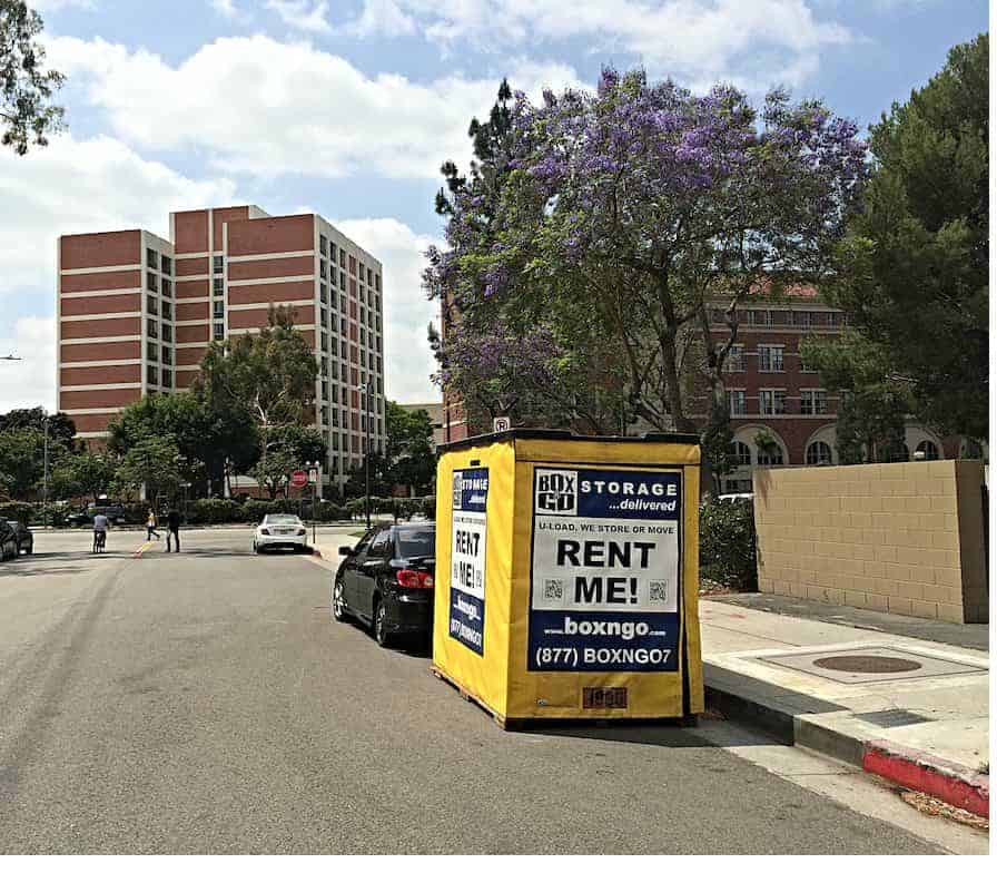 Box-n-Go storage near biola container beside Spanish homes in a street.