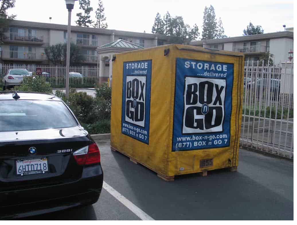 A student storage near Occidental College unit parked in a parking lot with fence visible.