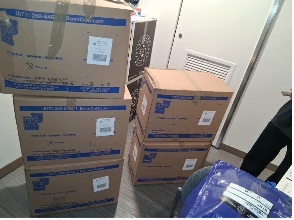 Student items including stacked boxes packed and labeled for Cal State Long Beach dorm storage.