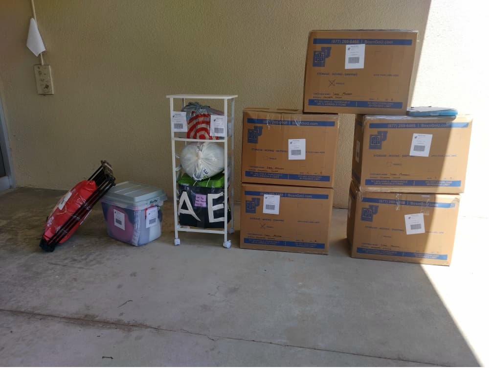 Student items including boxes and a shelf packed and labeled for college storage fullerton.