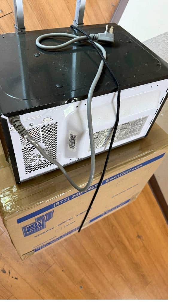 Student items including boxes on a cart packed and labeled for Pomona College storage services.