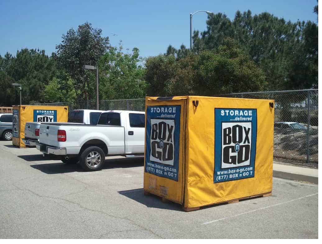 Portable storage units near csulb from Box-n-Go beside the pickup truck.