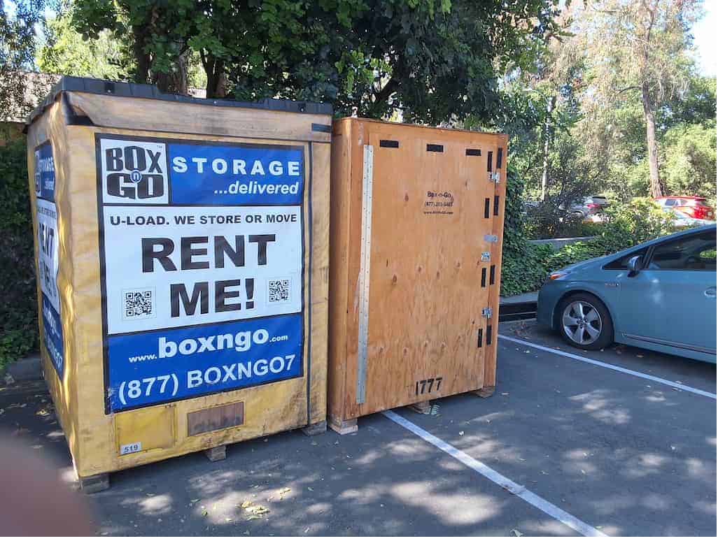 Yellow Box-n-Go uci storage container in a shaded lot near the Prius.