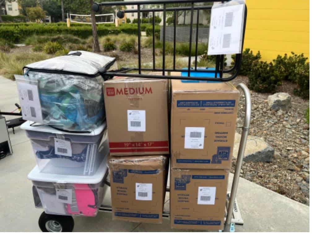 Student items including boxes and an electric scooter packed and labeled for Occidental College dorm storage.