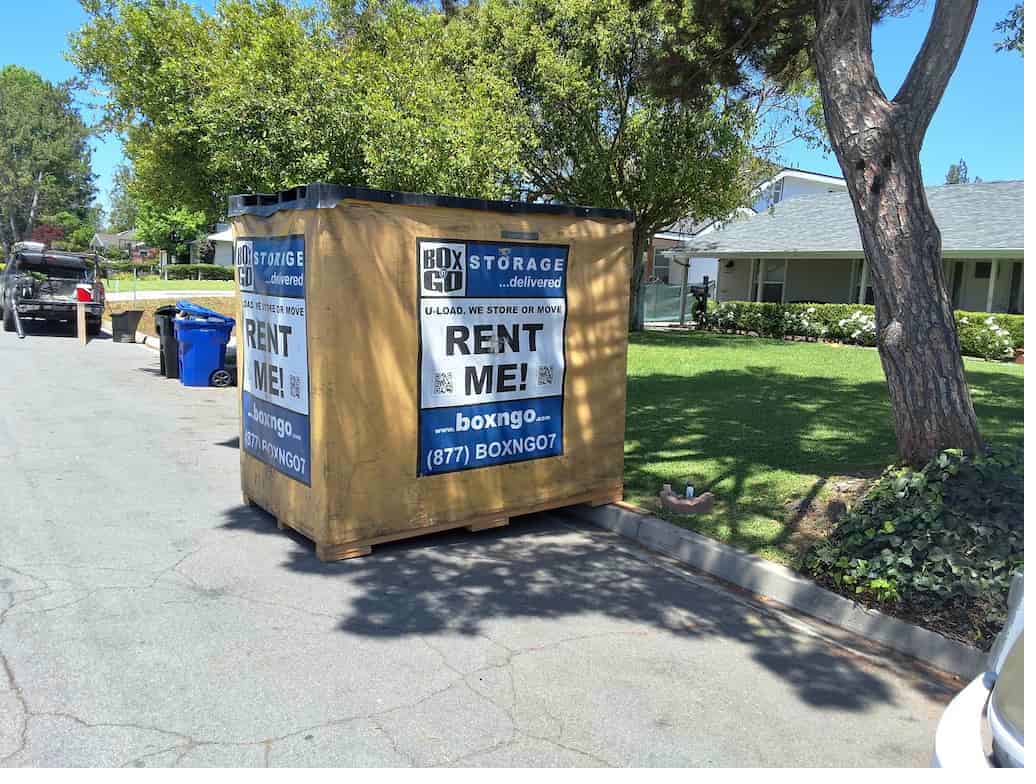 A storage near uci unit parked in a street with palms visible.