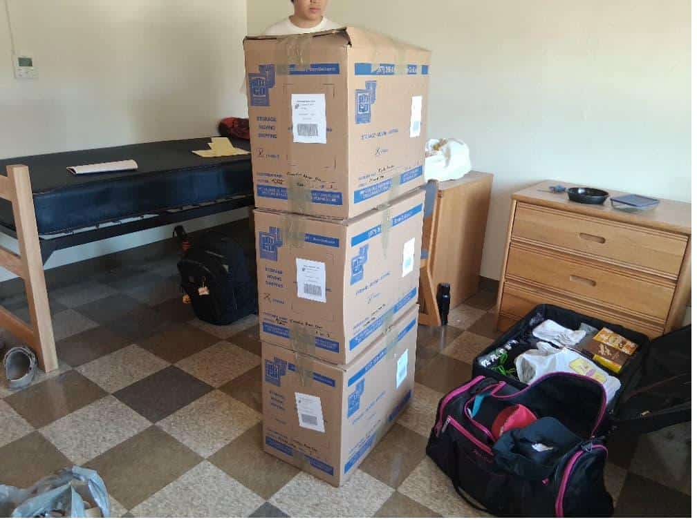 Student items including a tall stack of boxes packed and labeled for usc summer storage.