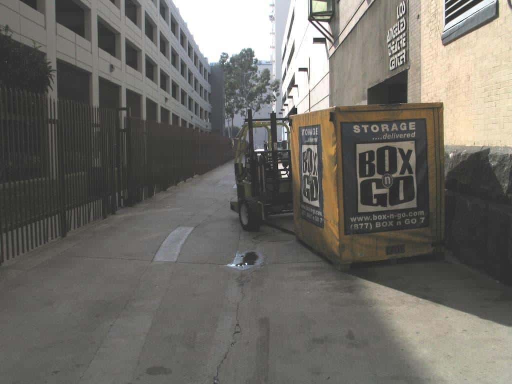 Box-n-Go storage units for students in an alley with a forklift nearby.