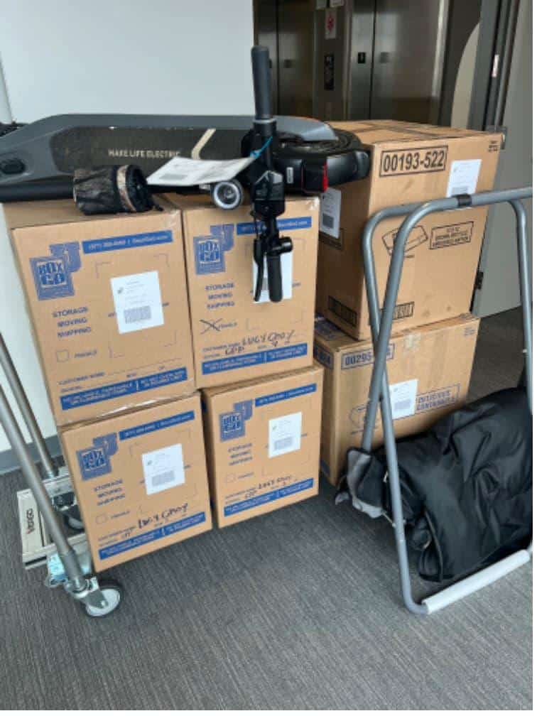 Student items including boxes and a mattress packed and labeled for college storage help.