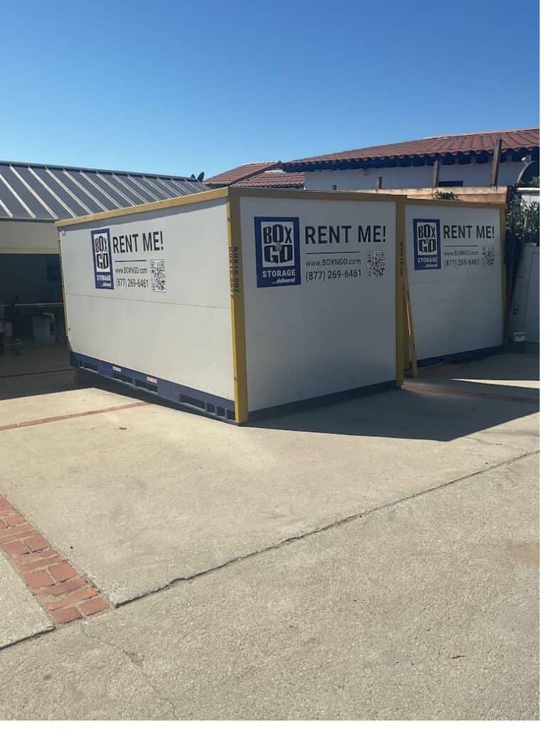 Two Box-n-Go portable storage containers on a customer's driveway, ready to load for a move