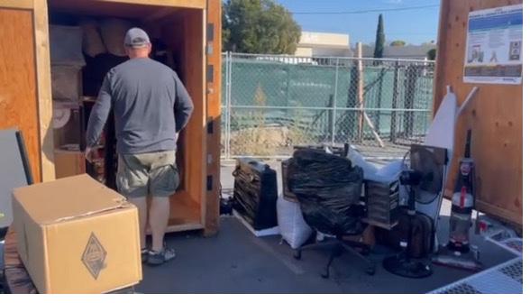 Customer accessing belongings at an open Box-n-Go storage container during a scheduled warehouse appointment