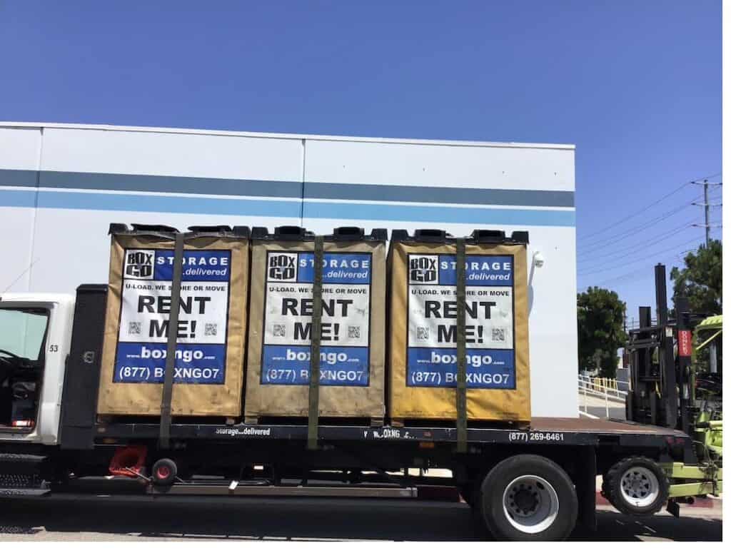 Box-n-Go truck loaded with three Flex storage containers ready for delivery, with forklift visible