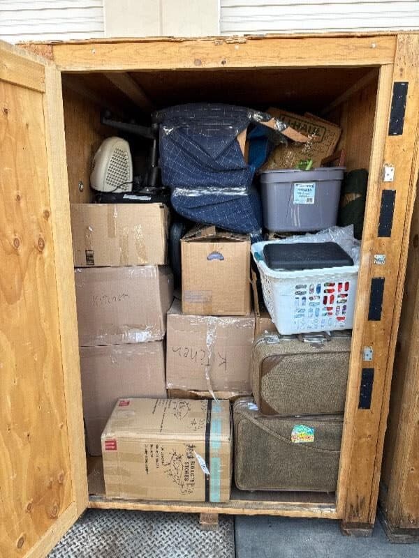 Open Box-n-Go storage container packed with labeled boxes, totes, and household items