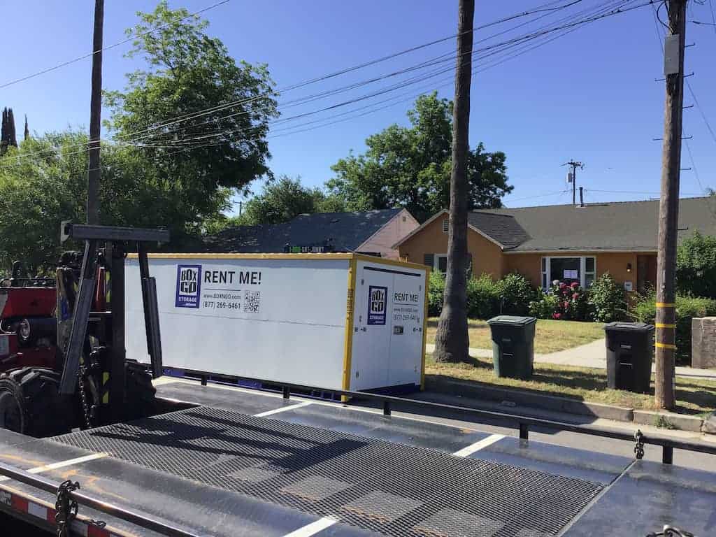 Arleta self storage container arriving on a Box-n-Go delivery truck at a residential street