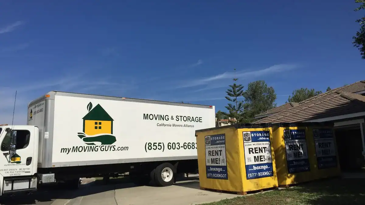 Moving truck and Box-n-Go storage containers on a driveway during a move
